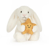 White plush bunny holding a gold star with a smiley face on a white background