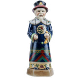 Ceramic figurine of a person in traditional attire with colorful patterns on a white background