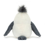 A plush toy seagull with soft cream fur, dark grey wings, thin pink legs, and a dark grey tuft on its head.