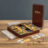 Clue board game set on a wooden table with cards and pieces.