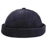 A navy blue corduroy beanie hat with a folded cuff, shown against a white background.