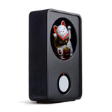 Black electronic device with a small window displaying a white cat figurine on a white background