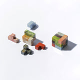 A multicolored gemstone Soma Cube Puzzle with a shadow on a white background.