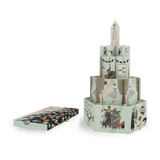 A vintage-style illustrated paper tower set with a matching box placed beside it on a plain white background. The tower is made of multiple printed paper panels with whimsical drawings, and the box shows a matching patterned cover.