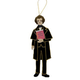 Ornament of a person in a black suit holding 'The Scarlet Letter' on a white background