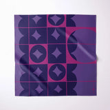 A square fabric with a geometric pattern in shades of purple, navy, and magenta, displayed flat against a clean white background.
