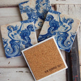Set of coasters with mermaid design on a rustic wooden surface