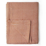Folded blanket with geometric pattern on a white background