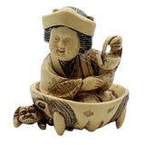 Otafuku netsuke, or Japanese toggle figurine on a white background