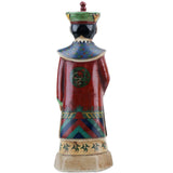 Ceramic figure with traditional attire on a white background