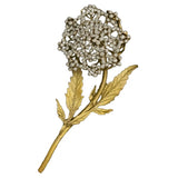 Gold brooch with a floral design on a white background