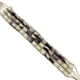 Beaded bracelet with white and purple shell beads on a white background