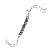 Beaded bracelet with white and purple shell beads on a white background