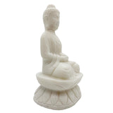 White stone statue of a seated Buddha on a white background