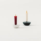 Two candle holders with candles on a white background