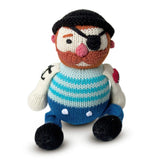 Knitted sailor toy with a black eye patch and blue striped shirt on a white background
