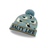 A light blue knit beanie with a pom-pom, featuring a pattern of seagulls and the words 'SALTY LIFE' on the cuff.