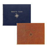 Two hardcover book-style covers labeled "SHIP'S LOG" with a compass rose emblem, shown on a white background. One cover is dark navy blue and the other is warm brown/cognac textured leather material.