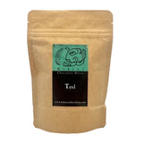A kraft paper stand-up pouch of Kakawa Chocolate House 'Tzul' chocolate, shown against a white background.