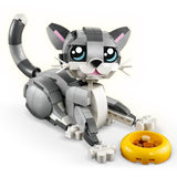 Toy cat figure made of interlocking bricks with a yellow bowl on a white background