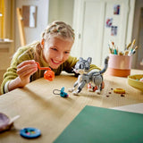 Child playing with toy figures at a table in a home setting