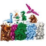 Assorted building blocks including dinosaur figures and various shapes on a white background