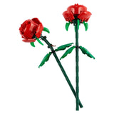 Two red roses made of interlocking bricks on a white background