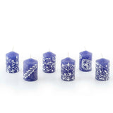 Set of six blue candles with white patterns on a white background