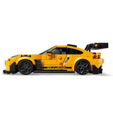 Yellow sports car model made of interlocking bricks on a white background