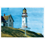 Lighthouse and house on a hill with a blue sky