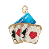 Coin purse with playing card design holding a blue credit card on a white background
