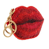 Red beaded lips-shaped keychain coin purse with gold accents on a white background