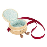 A plush cake-shaped crossbody bag with cream-colored frosting, red berries, a red and white striped candle, and a red strap, shown on a plain white background.