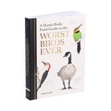 The book 'A Dumb Birds Field Guide to the Worst Birds Ever' by Matt Kracht, shown standing upright at a slight angle to display its black spine and front cover. The cover features detailed illustrations of three birds on a warm off-white background with gold lettering.