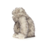 Plush toy resembling a creature with gray and white fur on a white background
