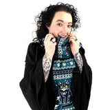 Person wearing a dark scarf with cat designs on a white background