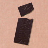 Chocolate bar with 'Spring & Mulberry' branding on a beige textured surface