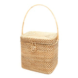 woven picnic basket with handle on a white background