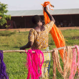 Woman working with colorful yarn in a field