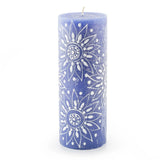 Blue candle with white floral pattern on a white background