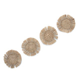 A set of four handwoven, natural fibre coasters in a spiral pattern with fringe edging.