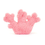 A plush toy resembling a pink coral with a smiling face and brown eyes