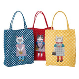 Three tote bags with cat designs on a white background