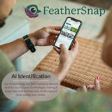 Two people holding a smartphone displaying the FeatherSnap app with a blurred background.