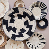Woven baskets with black and white patterns on a light background