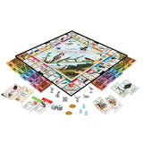 Board game titled 'Bird Spotting Opoly' with various cards and pieces on a white background