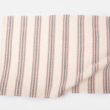 A striped towel in red, black and cream.