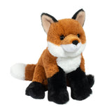 A small plush toy resembling a fox with a brown body, black feet, white markings, and a black nose.