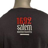 Back of black tee shirt with red and whit lettering that reads 1692 Salem Massachusetts.