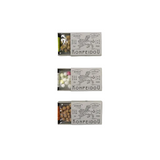 Three small Konpeidou boxes stacked vertically on a plain white background. The boxes are open to show the colorful candies inside, with the white cardboard labels featuring black line art of and the brand name KONPEIDOU.